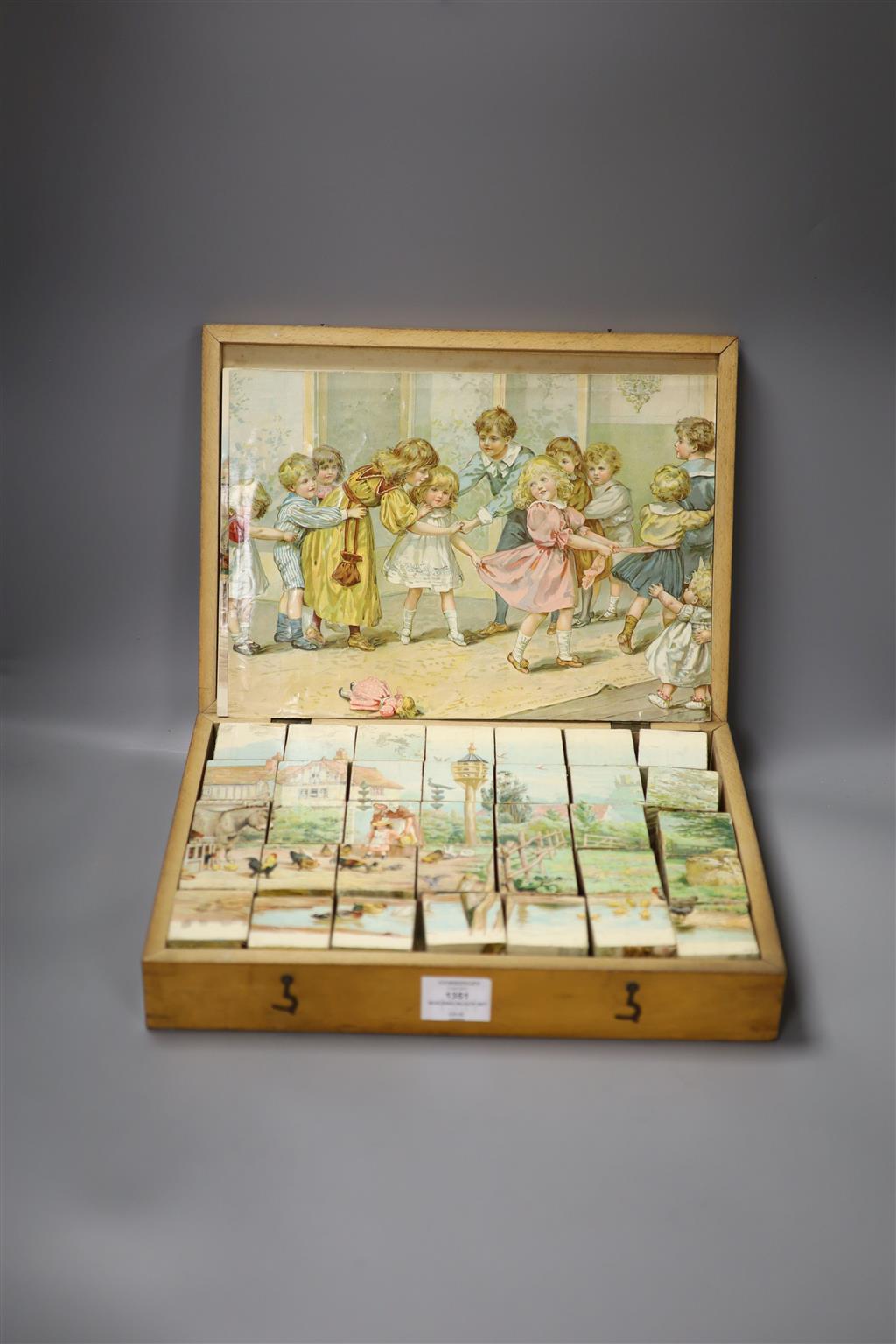 A Victorian chromo-lithographed building block set in original case.